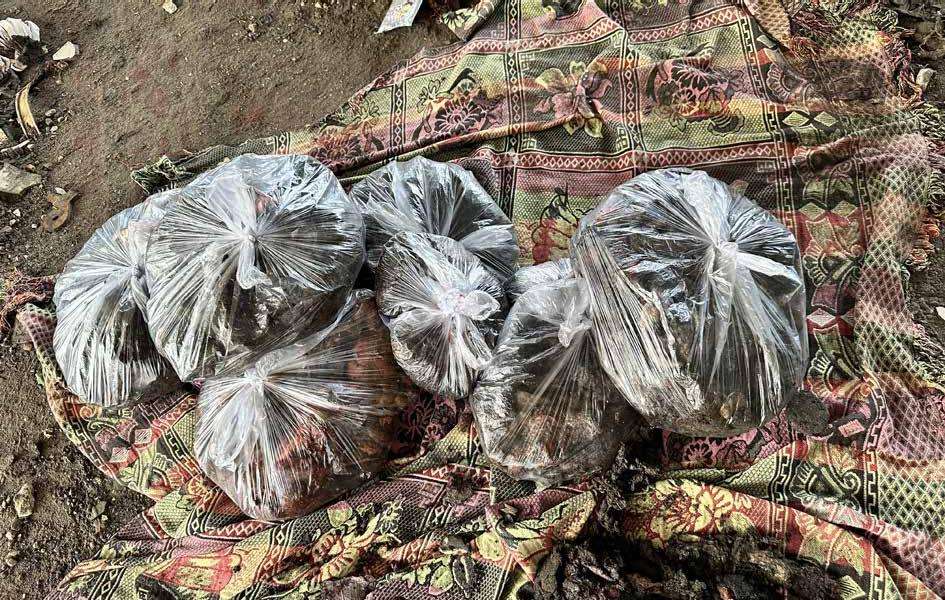 Body parts of those who died in the attack on the Al-Tabaeen School were placed in plastic bags for burial.