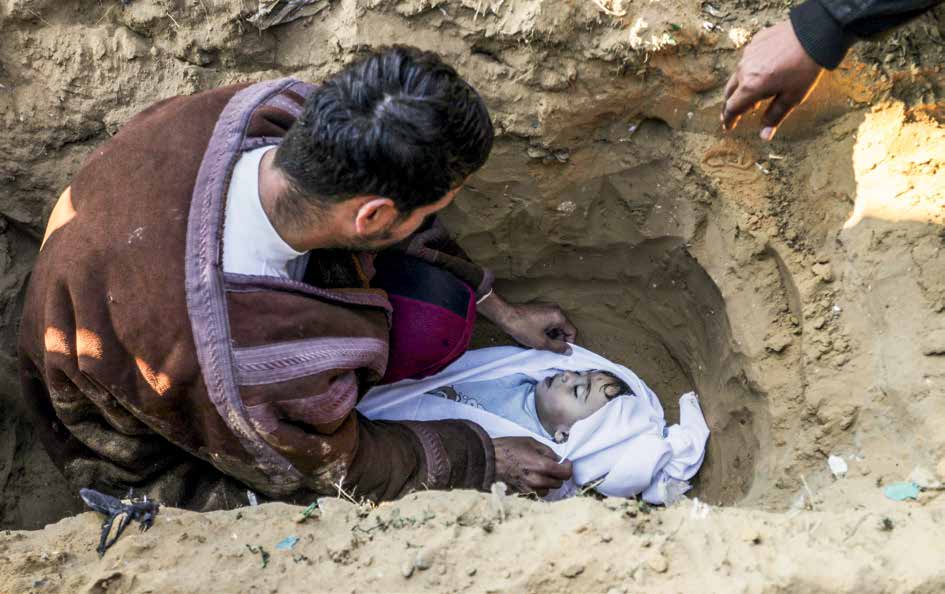 As a result of an Israeli army attack on the city of Khan Yunis, the building owned by the Muammar family was destroyed. The body of the Palestinian boy Abdurrahman Muammar, who lost his life in the attacks, is buried by his father in a cemetery in Khan Yunis.