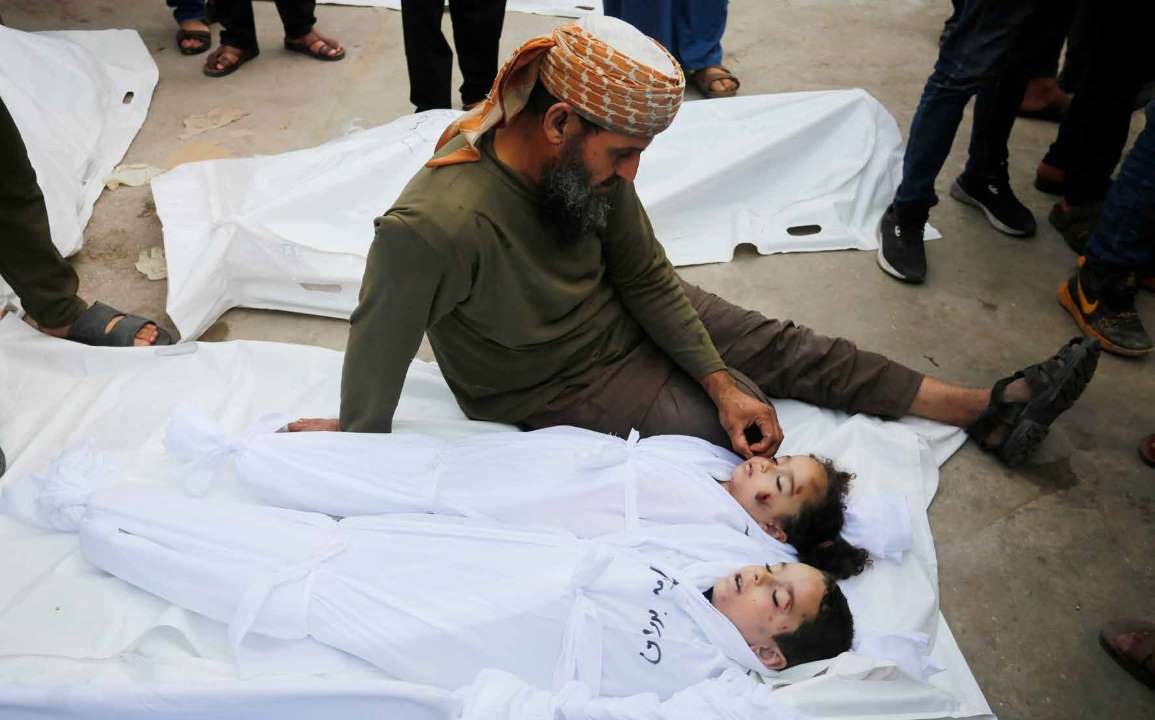 Khalid Nebhan bids farewell to his grandchildren at the Al-Aqsa Martyrs Hospital in Deir al-Balah. Rim and Tarik were killed in the Israeli military's attacks on the Gaza Strip. Nebhan shares that he now carries the lone earring left by his granddaughter Rim like a “badge” on his lapel.