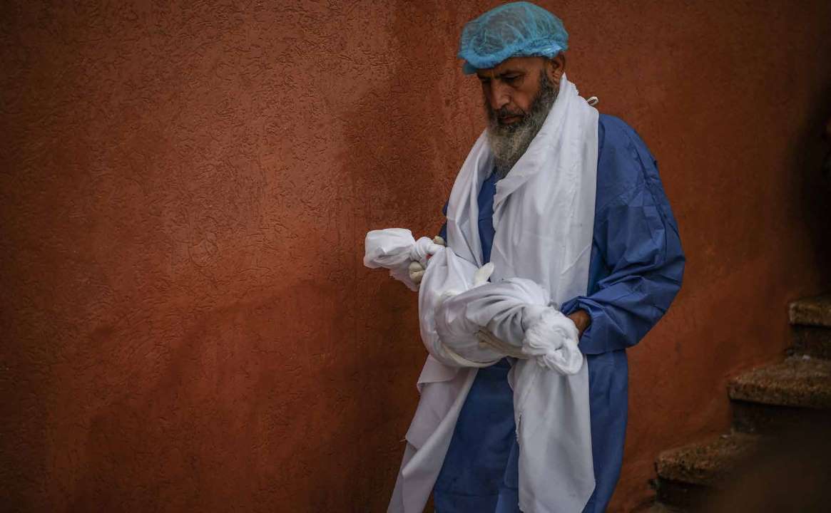 An infant, likely not even a year old, begins its journey from the Al-Nasser Hospital’s morgue towards its final resting place -- just another heartbreaking scene witnessed amidst the countless tragedies in Khan Yunis.