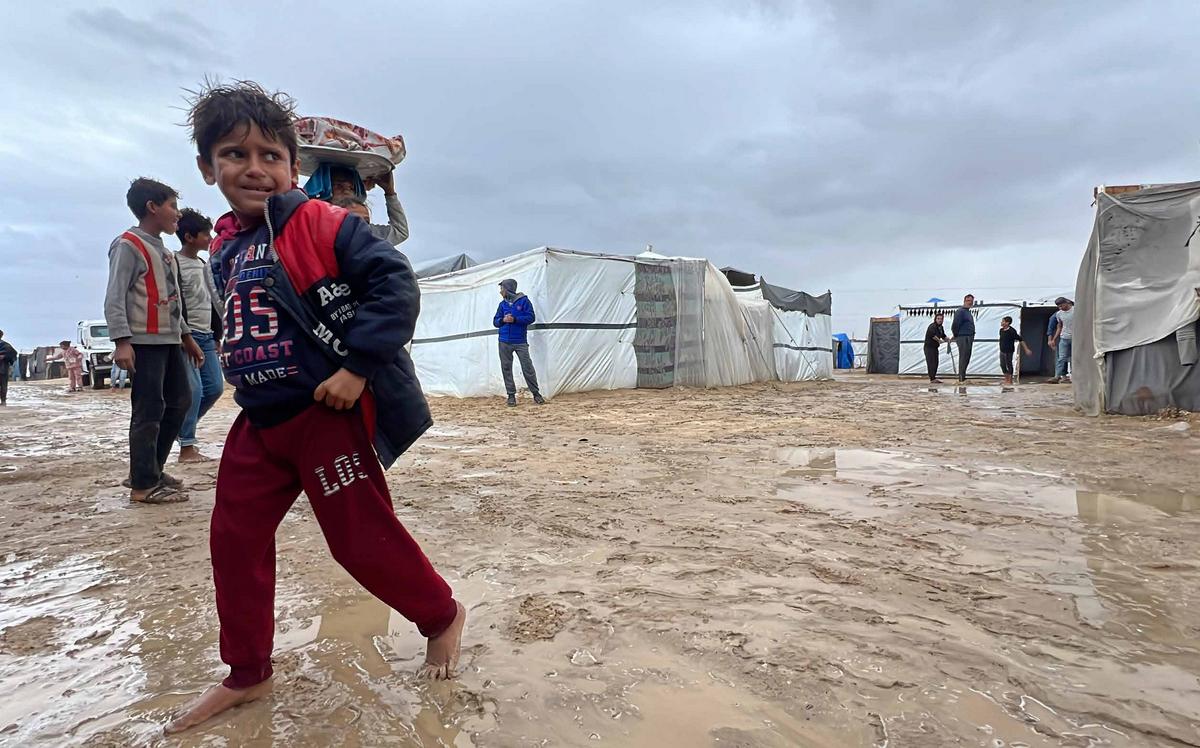 Palestinian families forcibly displaced by the Israeli army and sheltering in tent camps in Khan Yunis are enduring ongoing attacks as well as harsh weather conditions. Living in makeshift tents, they struggle to withstand the bitter cold while fighting to provide water and food for their children.