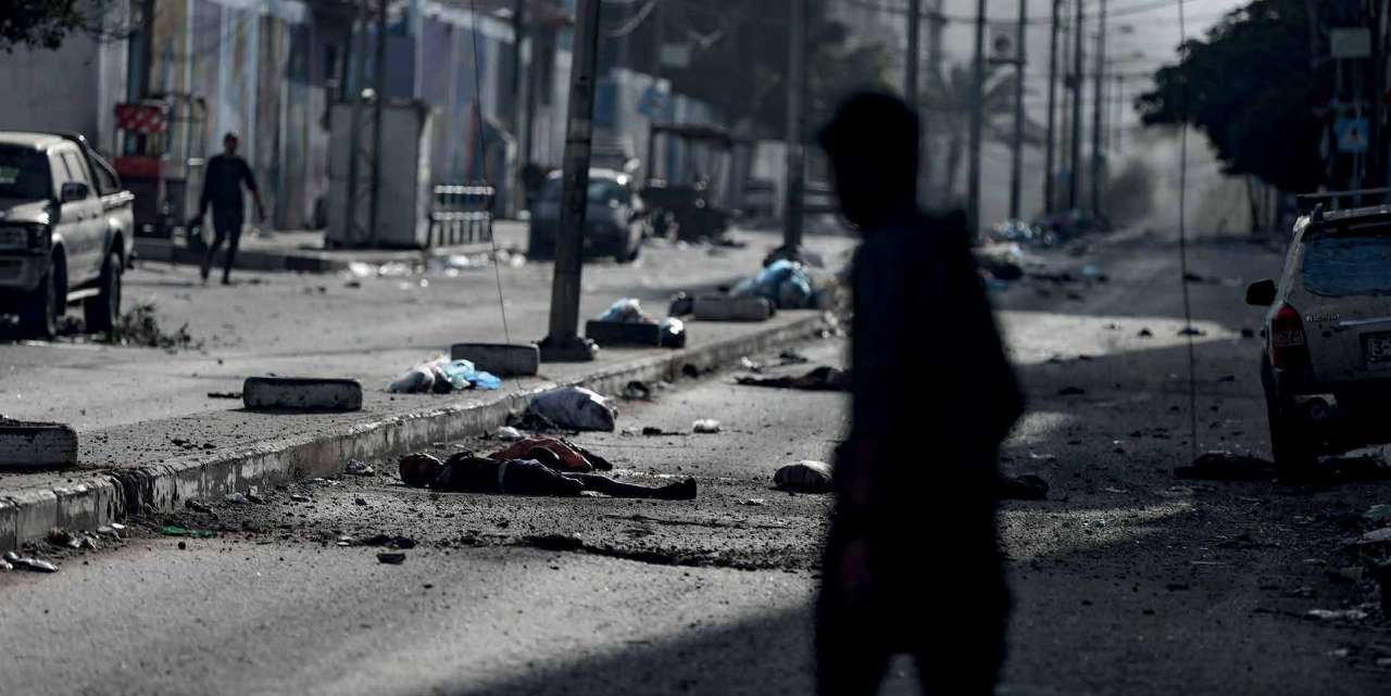 On the 33rd day of the Israeli army's attacks on Gaza, two dismembered bodies lie on the ground in Al-Naser Street near Al-Shifa Hospital, Gaza City.