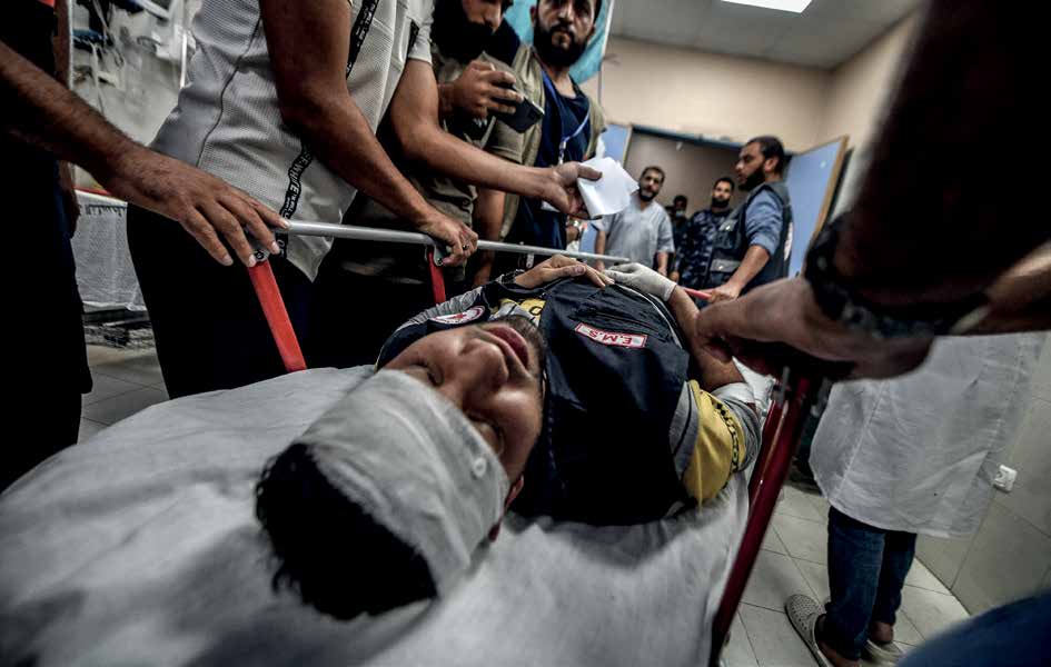 A health worker, injured in the ongoing Israel army airstrikes on the 10th day in Gaza, receives initial treatment at a hospital in Khan Yunis.