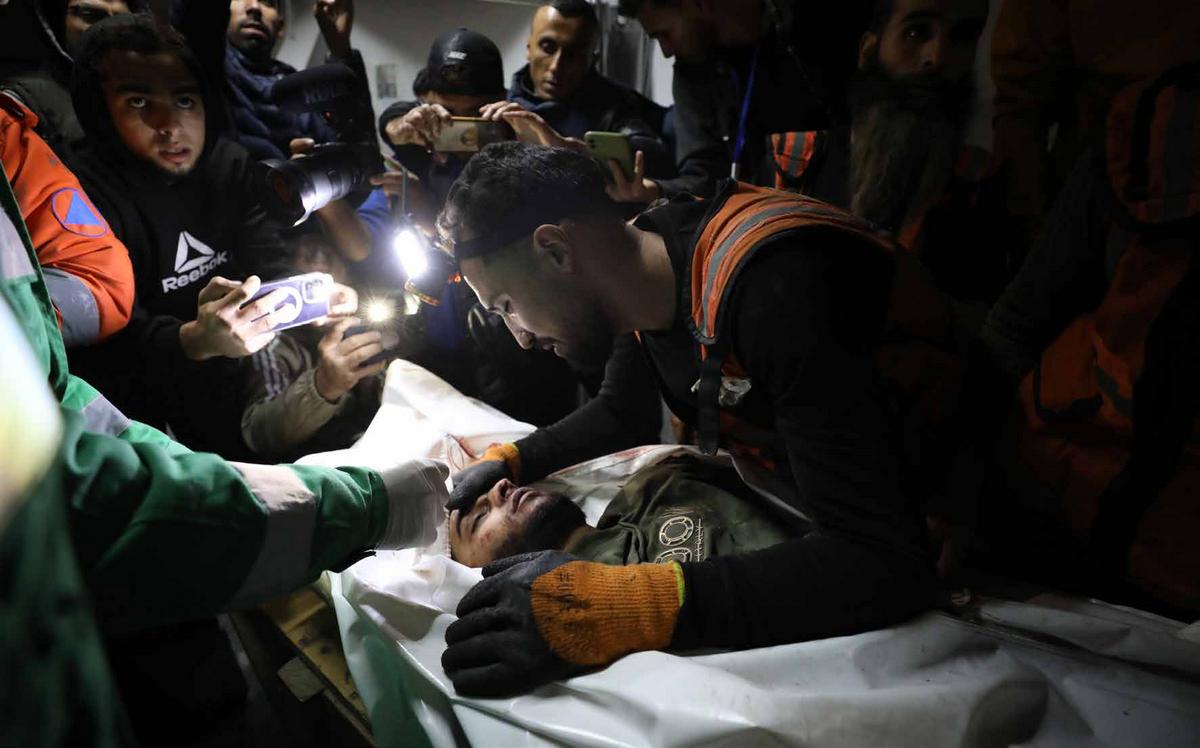 The bodies of Palestinian civil defense members killed in an Israeli attack on Sabra neighborhood have been brought to Al-Ahli Arab Baptist Hospital in Gaza.