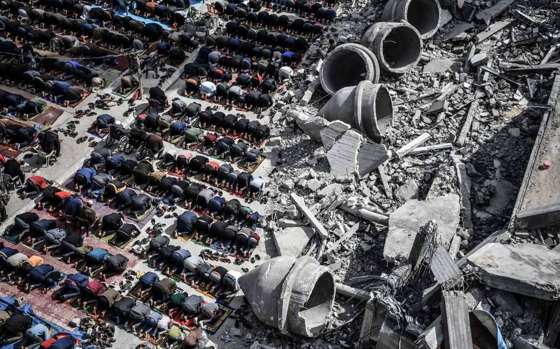 The Palestinians in the city of Rafah, Gaza, perform the Friday prayer amidst the rubble of the Al-Farouq Mosque, a.k.a. the Great Omari Mosque, destroyed in an Israeli attack.