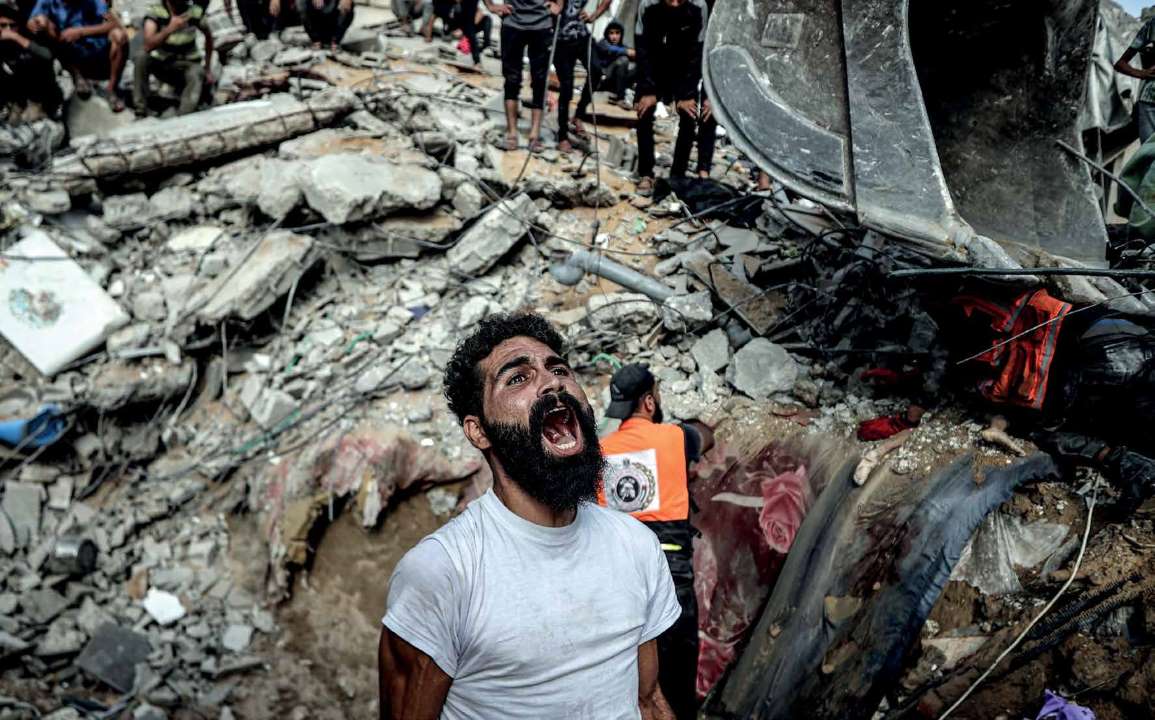 A building was completely destroyed in the attacks carried out by the Israeli army on the Al-Shati Refugee Camp in the west of Gaza city. Civil defense teams and local residents started a search and rescue operation. A Palestinian is crying out in anger and frustration.