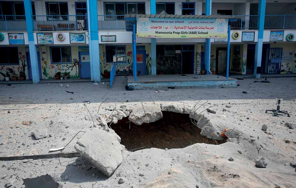 Following the Israeli warplanes' bombing raid, large craters formed in the courtyard of Mamounia Girls' High School in Gaza City.